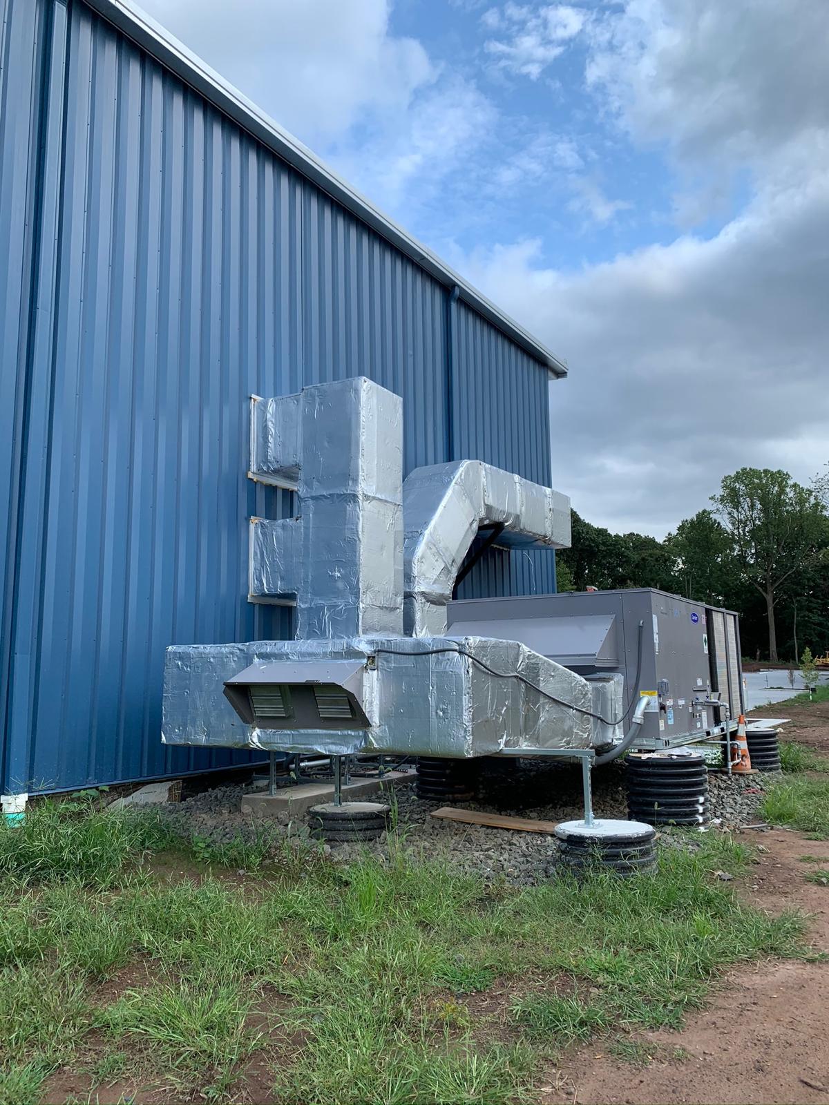 Commercial packaged HVAC unit with insulated exterior ductwork